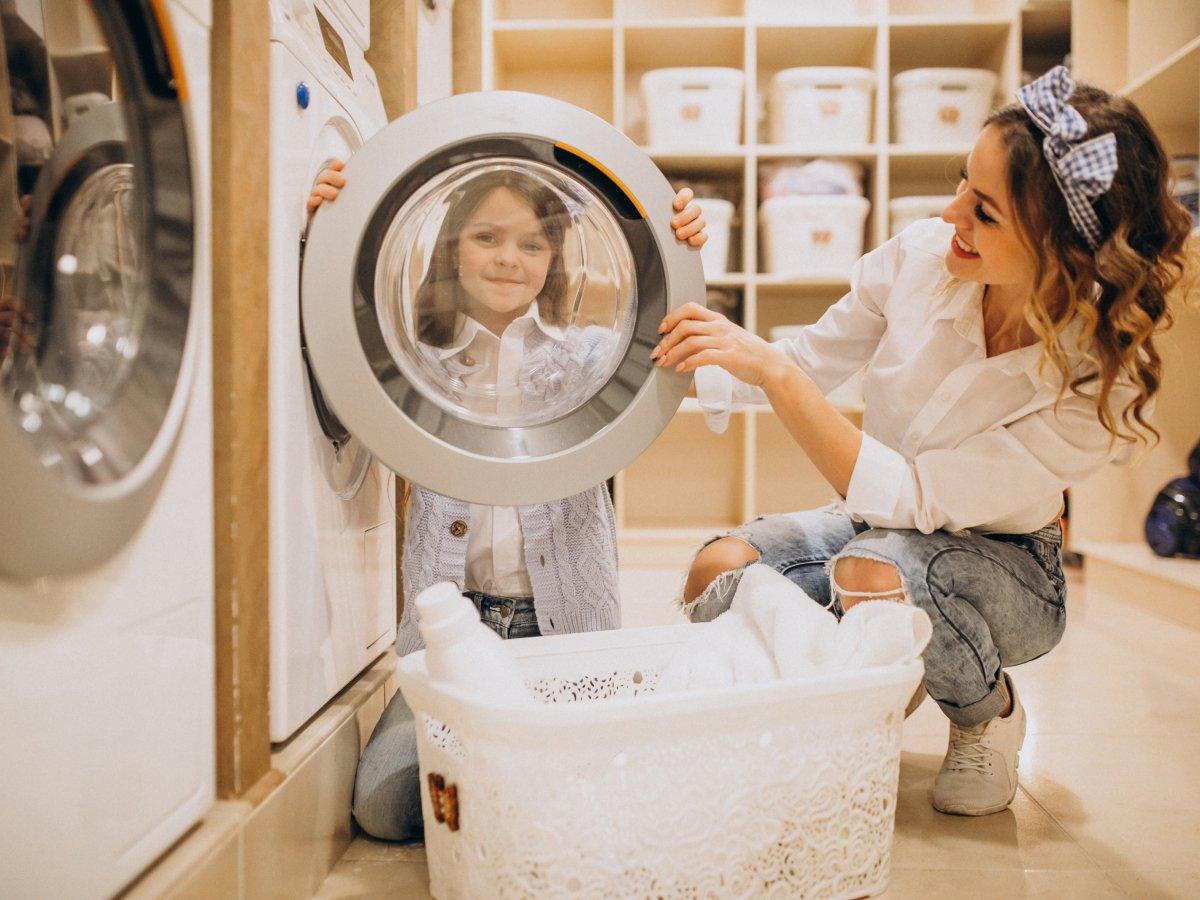 Child looking through dryer door window